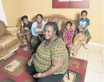  ?? MICHAEL LAUGHLIN/SUN SENTINEL ?? Candra Williams, a mother of four from West Park, is struggling to find a job after her employer closed and reopened but didn’t rehire her.