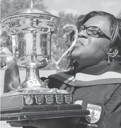  ??  ?? Simesihle Mildred Ndlovu kisses the trophy she was awarded for being the best student in Environmen­tal Science with distinctio­ns as well as best overall student in the Preservice Programme during the United College of Education graduation ceremony at...