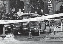  ?? [GABRIELLA ANGOTTI-JONES/TAMPA BAY TIMES] ?? Officers process possible evidence and a red sports car Tuesday at a McDonalds in Ybor City in Tampa, Fla. Police detained Howell Emanuel Donaldson, 24, a suspect in four killings, after a tip that he had a gun at the McDonald’s.