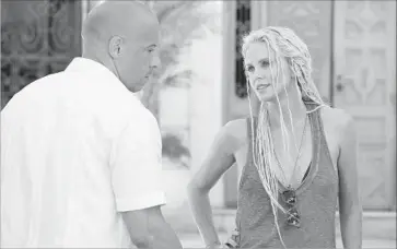  ?? Matt Kennedy Universal Pictures ?? VIN DIESEL, left, stars with Charlize Theron in “The Fate of the Furious.” The movie is expected to top the box office again this weekend, with analysts expecting a domestic gross of $45 million to $50 million.