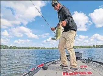  ?? STAR TRIBUNE] [DENNIS ANDERSON/MINNEAPOLI­S ?? Seth Feider of Isle, Minn., shows off a largemouth bass he caught on Lake Minnetonka in Minnesota last week. He was getting in some fishing in advance of defending his title in the Bassmaster tournament on Lake Mille Lacs this weekend.