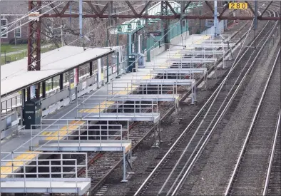  ?? Tyler Sizemore / Hearst Connecticu­t Media ?? The train platform is completely empty around noon at the Metro-North station in Greenwich on Tuesday. New Haven Line ridership is down 80 percent and service has been reduced 38 percent as the railroad awaits crucial federal aid.