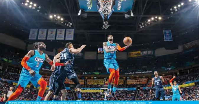  ??  ?? OKLAHOMA CITY: Paul George #13 of the Oklahoma City Thunder shoots the ball against the Orlando Magic on Tuesday at the Chesapeake Energy Arena in Oklahoma City, Oklahoma. — AFP