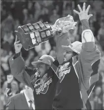  ?? Canadian Press photo ?? Windsor Spitfires left wing Jeremiah Addison, left, and defenceman Jalen Chatfield raise the trophy after defeating the Erie Otters to win the Memorial Cup in Windsor, Ont., on Sunday.