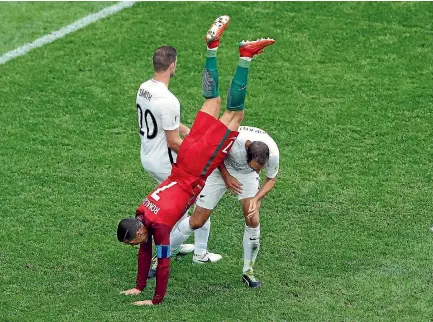  ?? PHOTO: REUTERS ?? Portuguese superstar Cristiano Ronaldo finds himself upended by All Whites defenders Tommy Smith, left, and Andrew Durante in St Petersburg.