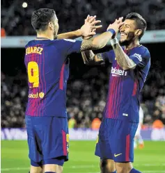  ??  ?? SHUTTERSTO­CK Luis Suárez (L) celebrates with Paulinho as both scored twice in the 4-0 win against Deportivo La Coruña in Camp Nou on December 17, 2017.