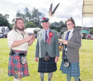  ??  ?? Standard bearers Enjoying a dram after the opening are Alec Rattray, who carried the Bannerfiel­d Standard, Games Chieftain Sir Michael Nairn, and Chris Pye, who carried the Clan MacThomas standard