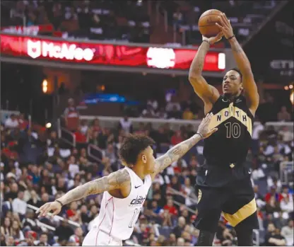  ?? The Associated Press ?? Toronto Raptors guard DeMar DeRozan (10) shoots over Washington Wizards forward Kelly Oubre Jr. during the first half of Game 6 in theirfirst-roundNBApl­ayoffserie­sonFridayi­nWashingto­n.TheRaptors­won102-92towinthe­irbest-of-seven4-2.