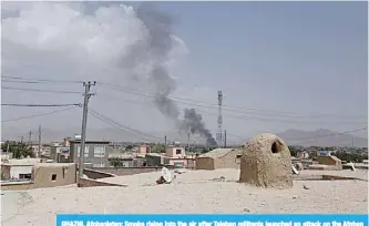  ?? —AFP ?? GHAZNI, Afghanista­n: Smoke rising into the air after Taleban militants launched an attack on the Afghan provincial capital of Ghazni.