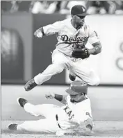  ?? LM Otero Associated Press ?? JIMMY ROLLINS forces out Rougned Odor of the Texas Rangers at second base in the fifth inning.