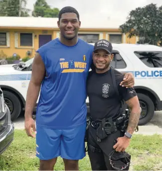  ?? JULIAN STROLENY ?? Michael Marshall, left, and Miami Police officer Raymon Washington.