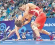  ?? KADIR CALISKAN ?? ■ Former world champion Sushil Kumar (in red) gave away a 9-4 lead to lose 9-11 in Nur-Sultan on Friday.