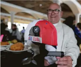  ?? James Nielsen / Houston Chronicle ?? Alberto Rodriguez gathers with other Cuban Americans on the news of Fidel Castro’s death at Cafe Piquet Cuban Cuisine in Houston.