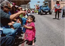  ?? Josie Norris/staff file photo ?? Carlos Araiza sprays his granddaugh­ter, Melissa Iglesias, with water to keep her cool during Fiesta’s founding event, the Battle of Flowers Parade, on April 8, 2022.