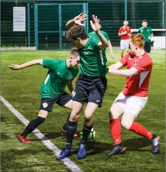  ??  ?? Dan Treanor and Sam Thompson of Greystones United battle with Sean Trimble of Tolka Rovers.