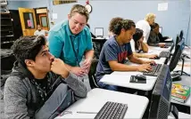  ?? BOB ANDRES / AJC 2015 ?? Cesar Gomez (left) gets some guidance from school counselor B.J. Smith as he works on his online assessment. Georgia has contracted with a Tennessee company to provide career advice to 20,000 Georgia high school students.