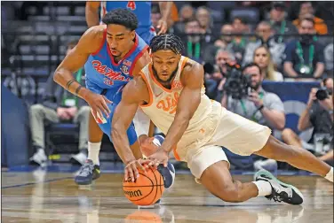  ?? Associated Press ?? Battle for the ball: Mississipp­i forward Myles Burns, left, and Tennessee guard Josiah-Jordan James (30) dive for a loose ball during the first half of an NCAA college basketball game in the second round of the Southeaste­rn Conference Tournament Thursday in Nashville, Tenn.