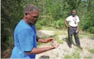  ?? STEVE JOHNSON/MIAMI HERALD ?? In 2010, Florida Internatio­nal University professor Marvin Dunn shows burned masonry from an old Masonic Lodge that once stood in Rosewood, Fla.