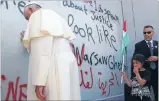  ?? Photo: REUTERS ?? Touching gesture: Pope Francis says a small prayer while touching the controvers­ial wall that divides Israel from the West Bank.