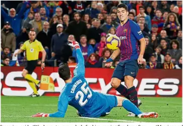  ??  ?? Baby brings luck: Barcelona’s Luis Suarez scoring their fourth goal and completes his hattrick against Real Madrid in a La Liga match on Sunday. — Reuters