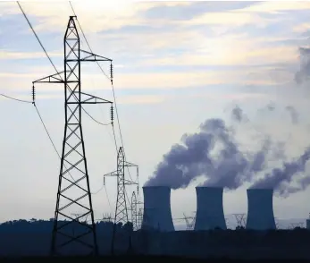  ??  ?? An Eskom coal fired power stations near Johannesbu­rg. The national power supply company has been slapped with a downgrade by Moody’s with a negative outlook.