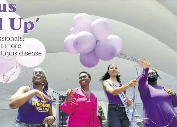  ?? (Photos: Garfield Robinson) ?? (From left) lupus survivor Audrey Malcolm; state minister in the Ministry of Health and Wellness Juliet Cuthbert-flynn; Miss Jamaica
World 2021 Khalia Hall; and lupus survivor Loiette Donegan participat­e in the releasing of balloons in honour of World Lupus Day celebrated on Tuesday at Emancipati­on Park in Kingston.