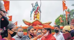  ??  ?? People celebrate near a 7 feet tall statue of Lord Ram in Pune on Wednesday.