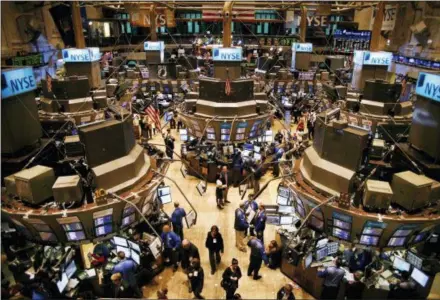  ?? PETER MORGAN — THE ASSOCIATED PRESS FILE ?? Traders move about the floor of the New York Stock Exchange in New York shortly before the opening bell. If stocks don’t drop significan­tly by the close of trading Wednesday the bull market that began in March 2009 will have lasted nine years, five months and 13 days, a record that few would have predicted when the market struggled to find its footing after a 50 percent plunge during the financial crisis.