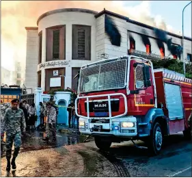  ??  ?? ATROCITY: Emergency services at Libya’s foreign ministry after the attack