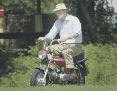  ??  ?? The Duke of Edinburgh riding a mini motorbike around the Royal Windsor Horse Show in 2002