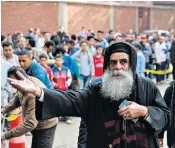  ??  ?? Egyptians at the cordoned off site of a gun attack outside a church in Cairo yesterday. Right, security forces stand guard at the targeted church in Helwan district