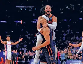  ?? ADAM HUNGER/THE ASSOCIATED PRESS ?? New York Knicks guard Jalen Brunson, top, jumps on teammate Josh Hart after Hart was fouled by the Detroit Pistons during the second half of Monday’s game in New York. The Knicks beat the Pistons 113-111.