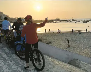  ?? COLLEEN THOMAS/TNS PHOTOS ?? Cyclists on a bike tour stop to gaze at the view along the oceanfront in Lima, Peru.