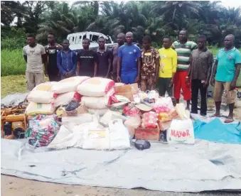 ??  ?? The suspects and the alleged smuggled items after their arrest by the Nigerian Navy at A/Ibom