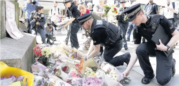  ??  ?? > Flowers are left in St Ann’s Square, Manchester, yesterday following the attack