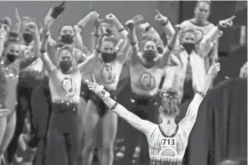  ?? AP PHOTO/MATT STRASEN ?? Oklahoma's Anastasia Webb celebrates with her teammates after her vault during the NCAA gymnastics semifinals Friday night in Fort Worth, Texas. Webb won the individual all-around title.