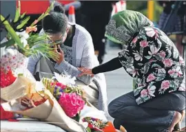  ?? Fiona Goodall Getty Images ?? PEOPLE IN CHRISTCHUR­CH, New Zealand, lay f lowers near the Al Noor Mosque in tribute to those killed in a terrorist attack during Friday prayers.