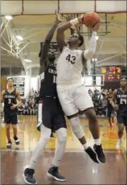  ?? GENE WALSH — DIGITAL FIRST MEDIA ?? Abington’s Eric Dixon drives to the basket against Plymouth Whitemarsh’s Naheem McLeod Friday night.