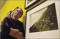  ?? ASSOCIATED PRESS ARCHIVES ?? Longtime Grateful Dead historian and author Dennis McNally is seen with a photo of the 1967 Human Be-In event at the California Historical Society in San Francisco in 2017.