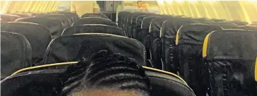  ??  ?? Anne Wafula Strike on the track and, left, her picture of the empty seats behind her as she was stranded on a plane at Stansted airport for 45 minutes waiting for assistance to get off