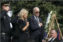  ?? MANUEL BALCE CENETA — THE ASSOCIATED PRESS FILE ?? President Joe Biden and first lady Jill Biden put their right hand over their heart after placing flowers on a wreath during a ceremony honoring fallen law enforcemen­t officers at the 40th annual National Peace Officers’ Memorial Service at the U.S. Capitol in Washington, Oct. 16, 2021. Saluting on the left is James Smallwood, National Treasurer of the National Fraternal Order of Police.