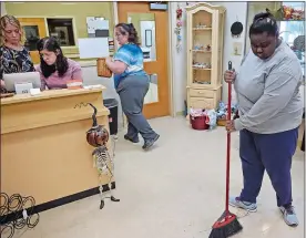  ?? SEAN D. ELLIOT/THE DAY ?? Bobbi Jo Ramsey, left, a job coach with The Arc New London County, works Monday with clients Anna Huffman, second from left, Cheryl Beatrice, center, and Ayndia Green at the Local Creations consignmen­t shop at the Groton Senior Center. The Arc has taken over operations of the store to provide job experience for some of the students with intellectu­al and developmen­tal disabiliti­es they serve.