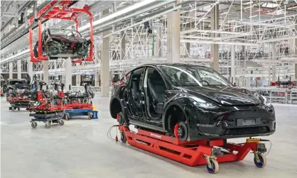  ?? ?? A Tesla Model Y on the production line at the firm’s factory in Grünheide, Brandenbur­g, Germany. Photograph: Dpa Picture Alliance/ Alamy