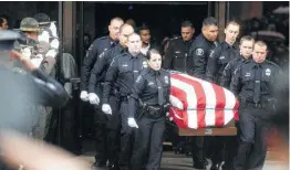  ??  ?? Newman, Calif., officers carry the body of their slain colleague Cpl. Ronil “Ron” Singh during funeral services Saturday in Modesto.