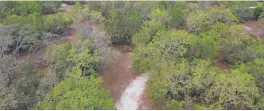  ?? RICARDO RAMIREZ BUXEDA/ORLANDO SENTINEL ?? An aerial view of the site of the planned River Cross developmen­t, in south Seminole County, near Orange County.