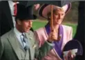  ??  ?? In this 1990 photo, Princess Diana and Prince Charles take shelter under an umbrella at the second day of the Royal Ascot horse race meet near London.
