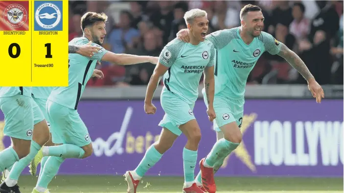  ??  ?? Leo Trossard and his teammates celebrate a late winner for Brighton at the Brentford Community Stadium