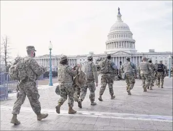  ?? Eric Thayer / Getty Images ?? National Guard troops assemble outside of the U.S. Captiol on Saturday in Washington. According to reports, as many as 25,000 National Guard soldiers will be guarding the city as preparatio­ns are made for the inaugurati­on of Joe Biden as the 46th president.