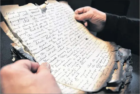  ?? SARA ERICSSON ?? Hal Theriault holds the charred remains of the ‘Electric City: The Stehelins of New France’ manuscript – one of the few things that survived the fire that totalled the Electric City heritage project’s headquarte­rs and future interpreti­ve centre in Weymouth.