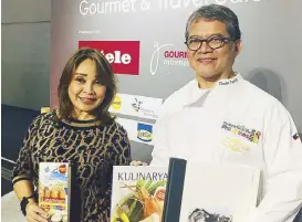  ??  ?? Three books at the Frankfurt Book Fair: Representa­tive Loren and the author showcasing Linamnam, Kulinarya, and the latest A Watercolor
Journey — a catalog of Tayag’s just-concluded retrospect­ive watercolor exhibition at the National Museum in Manila.